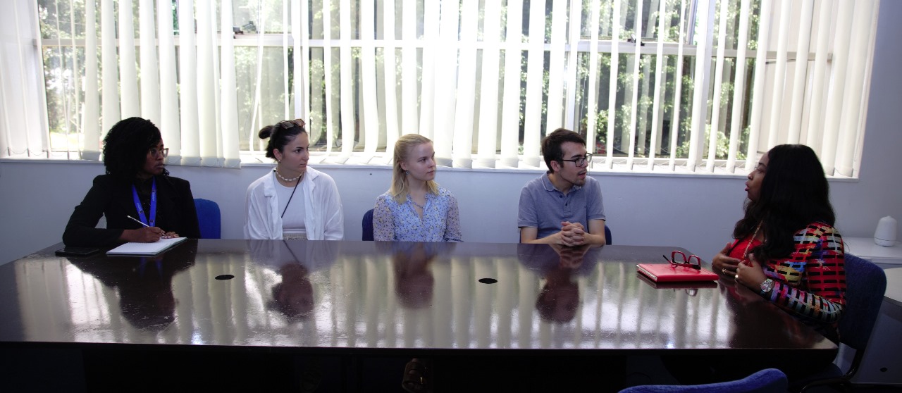 Staff from Baden-Wuerttemberg Cooperative State University listening to a presentation in the UoK DVCA's office.