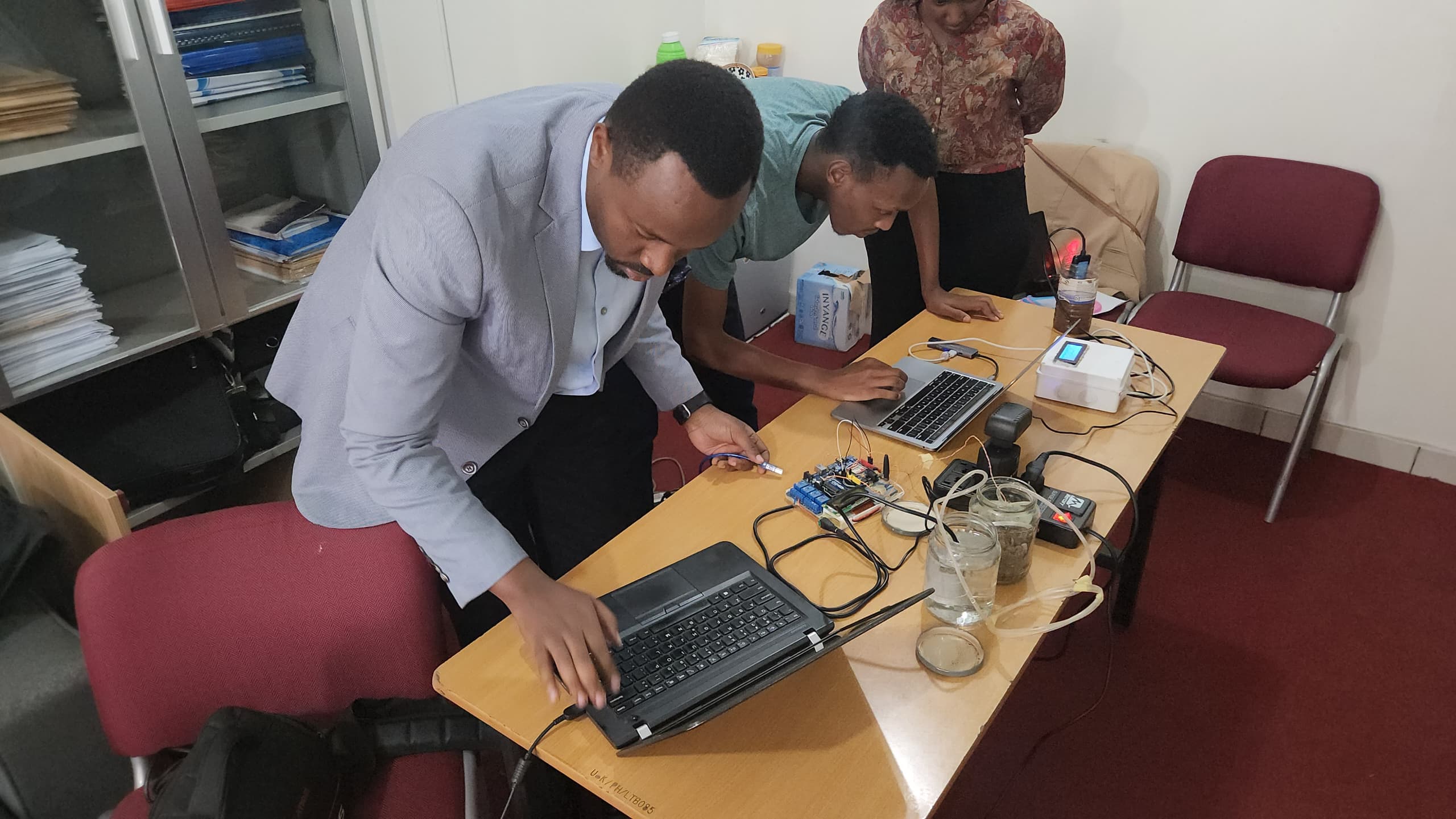 University of Kigali Researcher demonstrating the Smart Agriculture irrigation Prototype